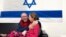 Irish-Israeli girl Emily Hand, who was abducted by Hamas gunmen, is reunited with her father, Thomas Hand, after being released, at an undisclosed location in Israel, in this handout image released Nov. 26, 2023.  (Israel Defense Forces/Handout via Reuters)