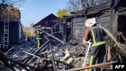 This handout photograph taken and released by the Ukrainian Emergency Service on Aug. 26, 2024 shows firefighters working at the site following an air attack, in Kyiv region. 