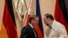 Philippine Defense Minister Gilberto Teodoro speaks with German Defense Minister Boris Pistorius as they shake hands after their joint news conference at a hotel in Makati, Metro Manila, Philippines, Aug. 4, 2024. 