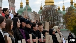 Relatives of Ukrainian Azov regiment war prisoners hold placards during a rally calling for their quick exchange with Russian prisoners of war at St. Sophia Square in Kyiv, on Oct. 18, 2023, amid the Russian invasion in Ukraine.