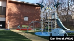 The inclusive playground at Transformation Academy in Baltimore, Maryland. In the background is a xylophone and drums where children can play music. (Dan Novak/VOA)