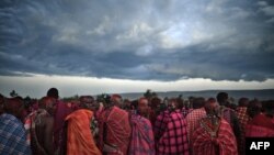 FILE - Men from the Maasai tribe perform a traditional song as they observe a rite of passage in Kenya February 27, 2021. Enkipaata, Eunoto and Olng'esher, three main Maasai rites of passage were inscribed since 2018 on the List of Intangible Cultural Heritage by UNESCO.