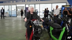 US Treasury Secretary Janet Yellen sits on a scooter while visiting a factory assembling electric scooters in Hanoi, Vietnam, July 20, 2023.