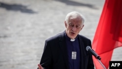 Auxiliary Bishop of Paris Philippe Marsset addresses the audience as he takes part in an interreligious meeting on the parvis of Notre Dame de Paris cathedral in Paris on Aug. 4, 2024.