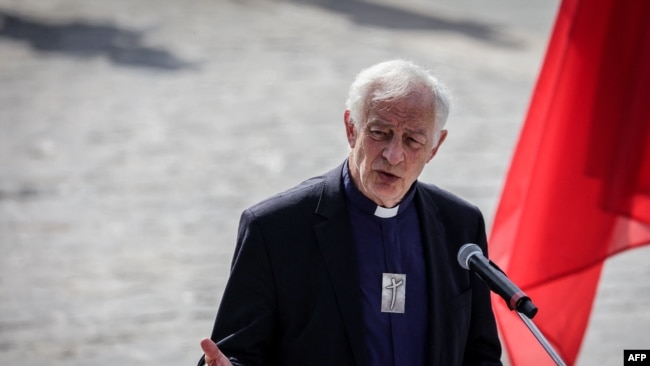 Auxiliary Bishop of Paris Philippe Marsset addresses the audience as he takes part in an interreligious meeting on the parvis of Notre Dame de Paris cathedral in Paris on Aug. 4, 2024.