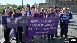 FILE - Supporters of Women's Ordination Conference (WOC), demonstrate to advocate and pray for the ordination of women near the Vatican in Rome, on Oct. 6, 2023.