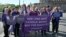 FILE - Supporters of Women's Ordination Conference (WOC), demonstrate to advocate and pray for the ordination of women near the Vatican in Rome, on Oct. 6, 2023.