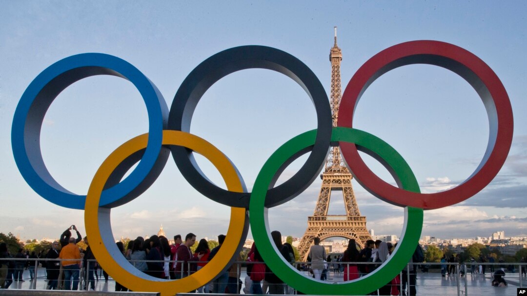 FILE - The Olympic rings are set up in Paris, France, Thursday, Sept. 14, 2017 at Trocadero plaza that overlooks the Eiffel Tower, a day after the official announcement that the 2024 Summer Olympic Games will be in the French capital. 