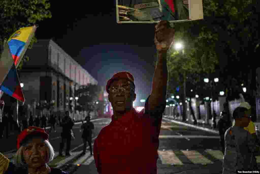 A supporter of President Nicolas Maduro celebrates the re-election of the Venezuelan leader for another six years in power on a street near the Miraflores Palace, in Caracas, July 29, 2024.