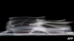 Japan's Misaki Emura competes against Uzbekistans Paola Pliego, right, in the womens Sebre team final fencing event during the 2022 Asian Games in Hangzhou in China's eastern Zhejiang province.