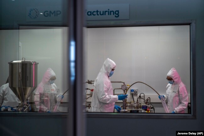 FILE - Scientists re-enact the calibration procedure of equipment at an Afrigen Biologics and Vaccines facility in Cape Town, South Africa, Tuesday Oct. 19, 2021. (AP Photo/Jerome Delay, File)