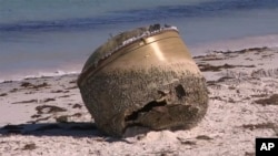 In this image made from video, a cylindrical object is seen on a beach in Green Head, Australia, July 17, 2023.