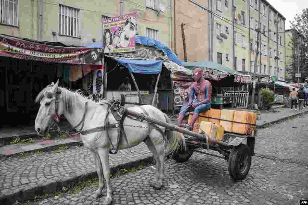 A man dressed in a Spiderman costume and known as Ethio-Spiderman sits on a horse cart in Addis Ababa, Ethiopia.