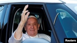 Pope Francis rides in a car on the day of his discharge from Gemelli hospital in Rome, June 16, 2023.