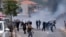 Druze protesters clash with Israeli police who fired tear gas as thousands took part in a demonstrations against the construction of massive wind turbines, in the Golan Heights, June 21, 2023. 