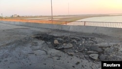 The damaged Chonhar bridge connecting Russian-held parts of Ukraine's Kherson region to the Crimean peninsula is seen in this picture released June 22, 2023, following what Russian-appointed officials say was a Ukrainian missile attack.