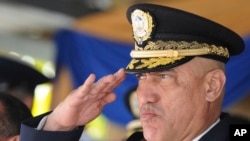 FILE - Honduras Police Chief Gen. Juan Carlos Bonilla Valladares, also known as the Tiger, or 'El Tigre,' salutes during an event in Tegucigalpa, Honduras, Dec. 21, 2012. 