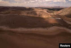 A drone view shows the dry bed of the Las Lajas dam where thousands of dead fish lie due to a severe drought, in Buenaventura, Chihuahua state, Mexico, Aug. 23, 2024.