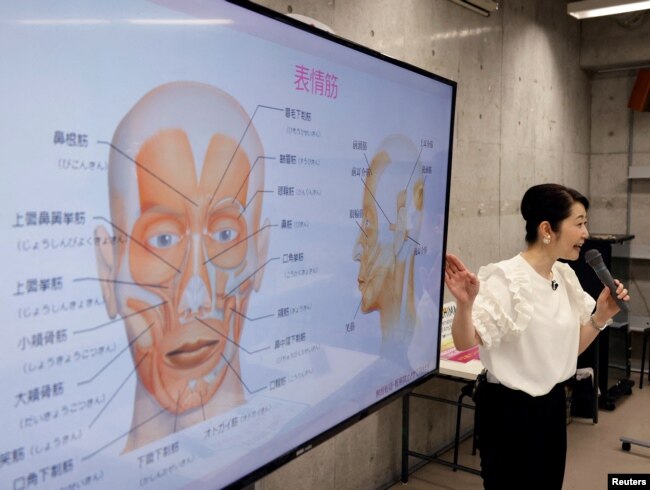 FILE - Smile coach Keiko Kawano teaches students at a smile training course at Sokei Art School in Tokyo, Japan, May 30, 2023. REUTERS/Kim Kyung-Hoon