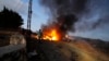 A journalist's car burns after it was hit by shelling in a Lebanese border village with Israel, Oct. 13, 2023. A gathering of journalists covering border clashes were hit during Israeli strikes on its border with Lebanon in response to attacks, killing one and injuring six.