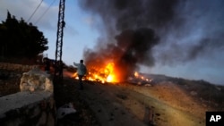 A journalist's car burns after it was hit by shelling in a Lebanese border village with Israel, Oct. 13, 2023. A gathering of journalists covering border clashes were hit during Israeli strikes on its border with Lebanon in response to attacks, killing one and injuring six.