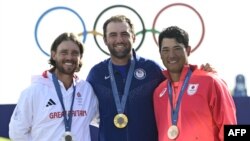 (From L) Silver medalist Britain's Thomas Fleetwood, gold medalist US' Scottie Scheffler and bronze medalist Japan's Hideki Matsuyama pose for pictures after round 4 of the men's golf individual stroke play of the Paris 2024 Olympic Games, Aug. 4, 2024.