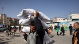 A man carries away bags of humanitarian aid in Rafah in the southern Gaza Strip, Nov. 26, 2023. 