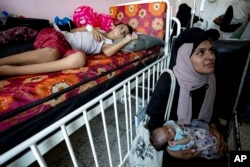 Palestinian children wait to receive polio vaccinations at a hospital in Khan Younis, Aug. 31, 2024.