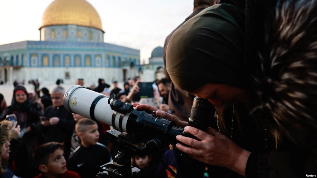 Members of the Palestinian Astronomical Society and Waqf team use a telescope to look for a crescent moon ahead of the Muslim holy month of Ramadan, at Al-Aqsa compound, known to Jews as Temple Mount, in Jerusalem's Old City, March 10, 2024.