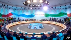 Russian President Vladimir Putin, center, speaks during a plenary session at the Russia Africa Summit in St. Petersburg, Russia, July 28, 2023.