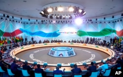 Russian President Vladimir Putin, centre, speaks during a plenary session at the Russia Africa Summit in St. Petersburg on July 28, 2023. (Donat Sorokin/TASS/via AP)