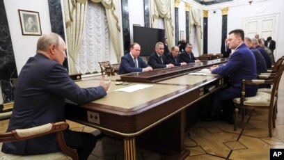 FILE - Russian President Vladimir Putin, back to the camera, chairs a Security Council meeting in Moscow, Russia, June 26, 2023.
