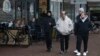 Migrants walk outside a shopping mall in Ter Apel, northeastern Netherlands, Nov. 9, 2023, as the country heads into elections with migration a key topic.