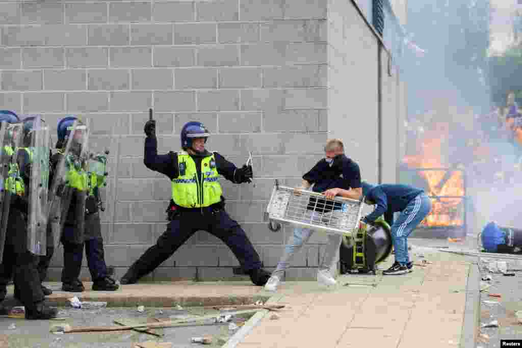 A police officer clashes with a protester outside a hotel in Rotherham, Britain. Police in the north of England town were struggling to hold back a mob of far-right rioters who were seeking to break into a hotel believed to be housing asylum seekers.