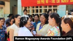 This undated photo provided by the Ramon Magsaysay Award Foundation shows 2024 Ramon Magsaysay Awardee, Nguyen Thi Ngoc Phuong, center, from Vietnam. (Ramon Magsaysay Awards Foundation via AP)