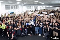 FILE - Tesla Chief Executive Officer Elon Musk poses for a group photo at the Shanghai Gigafactory of the U.S. electric vehicle maker in Shanghai, China, in this handout image released on June 1, 2023. (Tesla/Handout via REUTERS)