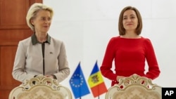 FILE - European Commission President Ursula von der Leyen, left, stands next to Moldova's President Maia Sandu during von der Leyen's visit to Chisinau, Moldova, Oct. 12, 2023. 