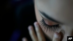 FILE - A dancer applies false eyelashes in Caracas, Venezuela, Dec. 7, 2022. Many of the wigs and false eyelashes labeled “Made in China” that are sold by American retailers may violate U.S. sanctions on North Korea, where they are actually manufactured, according to experts.