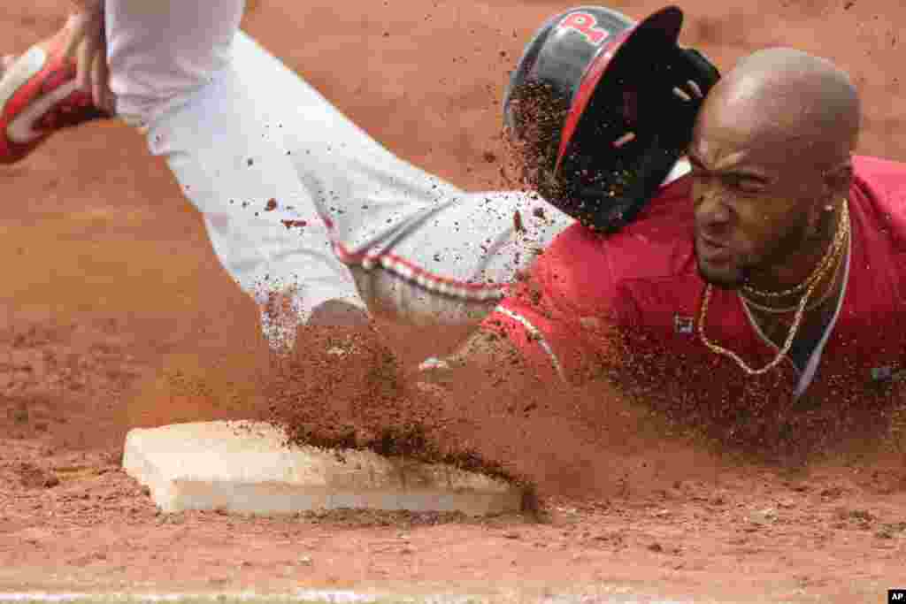 Panama&#39;s Edgar Munoz slides safely to first after batting during a baseball game against Mexico at the Pan American Games in Santiago, Chile.&nbsp;Panama won 8-2.&nbsp;