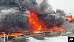 In this photo taken from video released by Governor of Bryansk Region Alexander Bogomaz telegram channel AV BogomaZ on Friday, Jan. 19, 2024, Oil reservoirs are seen in fire after the drone reached Klintsy.
