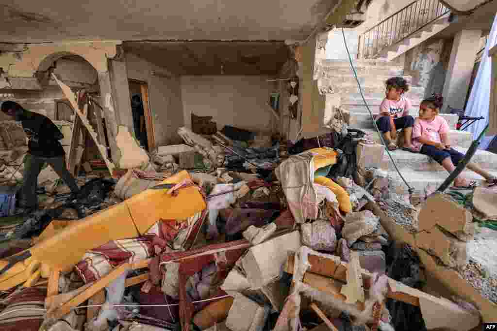 Children look at a destroyed flat in the occupied West Bank city of Jenin after the Israeli army declared the end of a two-day military operation in the area.