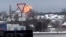 In this handout photo taken from validated UGC video, flames are rising from the scene of a warplane crashed at a residential area near Yablonovo, Belgorod region, Jan. 23, 2024. 