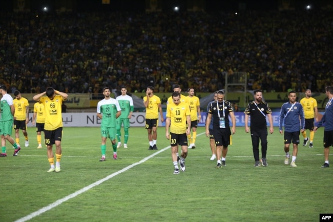 Players leave the pitch after the cancellation of the football match between Iran's Sepahan and Saudi Arabia's Al Ittihad at the Naghsh-e-Jahan Stadium in Isfahan, Oct. 2, 2023, in this picture obtained by AFP from the Iranian news agency Tasnim.