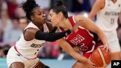 Alexis Peterson (1), of Germany, defends Kelsey Plum (5), of the United States, in a women's basketball game at the 2024 Summer Olympics, in Villeneuve-d'Ascq, France, Aug. 4, 2024.