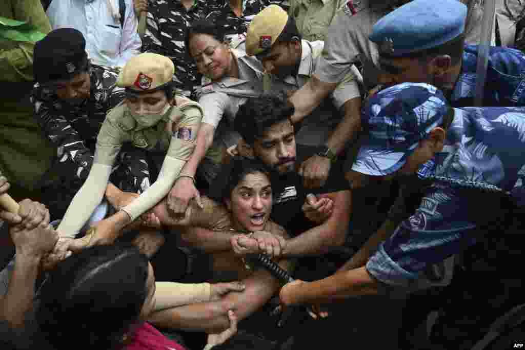 Indian police detain wrestlers Vinesh Phogat (C) with others while attempting to march to India&#39;s new parliament, just as it was being inaugurated by Prime Minister Narendra Modi, in New Delh,&nbsp;during a protest against Brij Bhushan Singh, the wrestling federation chief, over allegations of sexual harassment and intimidation.