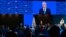 International Olympic Committee (IOC) President Thomas Bach (C, right) addresses delegates on the first day of the 141st IOC Session in Mumbai, India, Oct. 15, 2023.