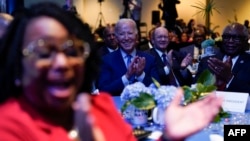 U.S. President Joe Biden listen to speakers during the South Carolina's First in the Nation Dinner at the South Carolina State Fairgrounds in Columbia, South Carolina, Jan. 27, 2024.