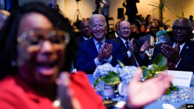 U.S. President Joe Biden listen to speakers during the South Carolina's First in the Nation Dinner at the South Carolina State Fairgrounds in Columbia, South Carolina, Jan. 27, 2024.