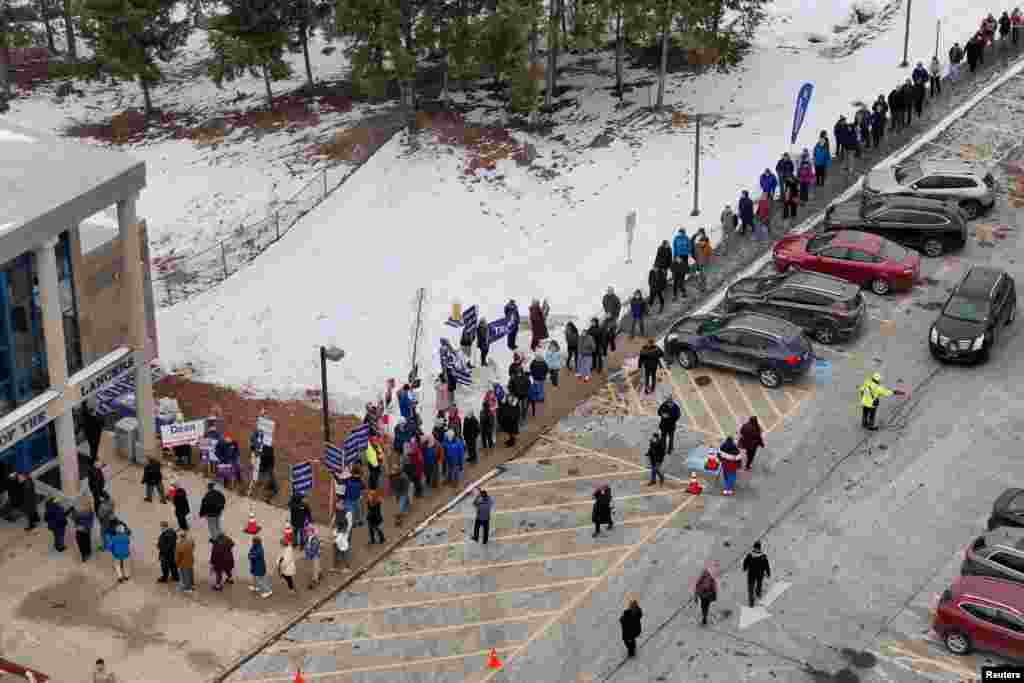 Voters line up to cast their ballots in the New Hampshire primary election in Londonderry, New Hampshire.