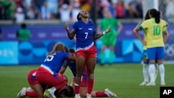 Crystal Dunn of the United States celebrates with team mates after defeating Brazil during the women's soccer gold medal match between Brazil and the United States at the Parc des Princes, Aug. 10, 2024, in Paris.